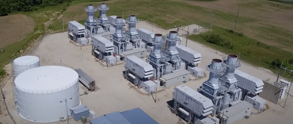 Aerial view of a site with 4 natural gas units and a storage tank